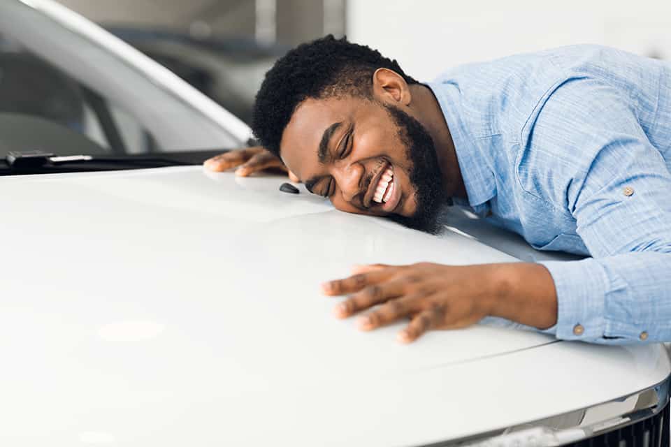 Man hugging new car