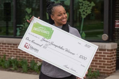 Tiffany holds oversized Saver's Sweepstakes check